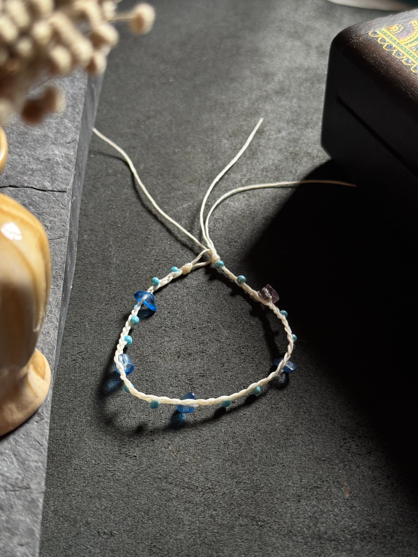 White macramé anklet with blue stones