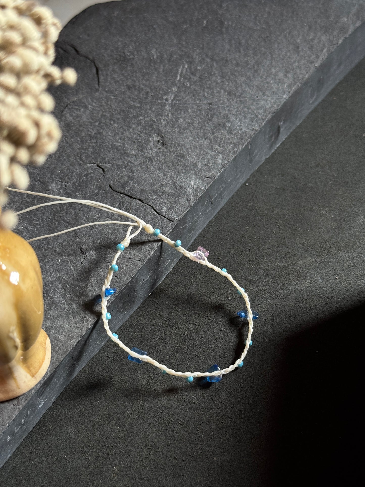 White macramé anklet with blue stones
