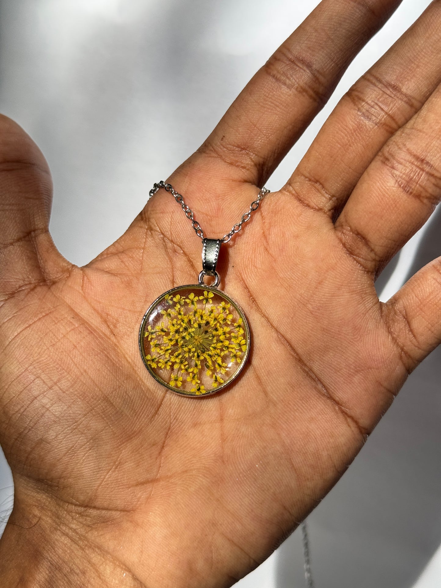Yellow queen anne's lace round stainless steel necklace