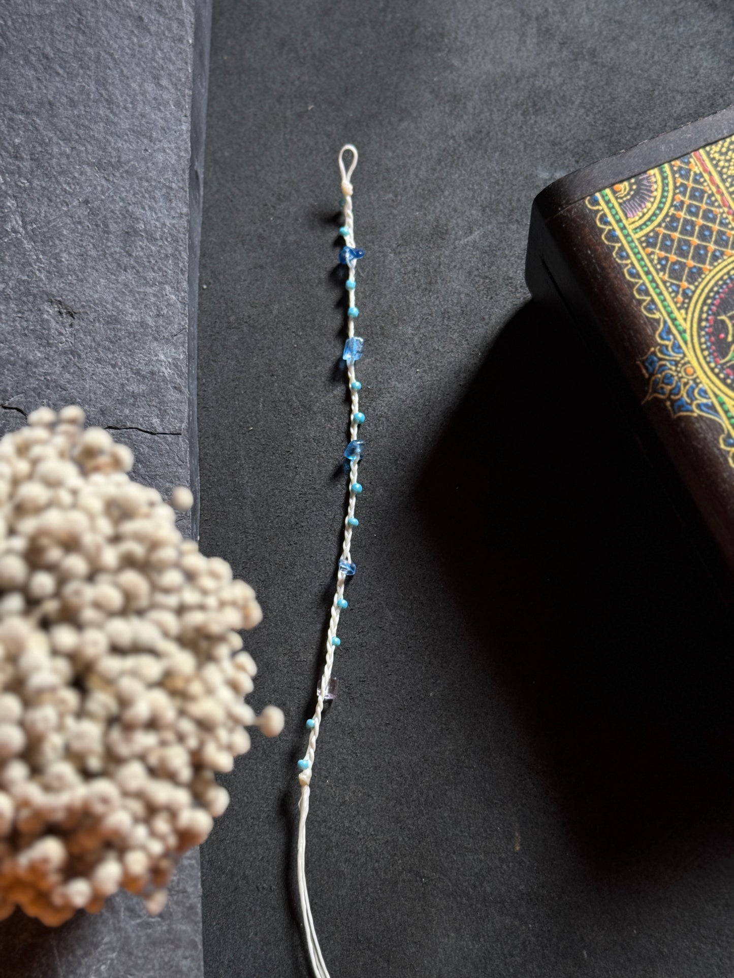 White macramé anklet with blue stones
