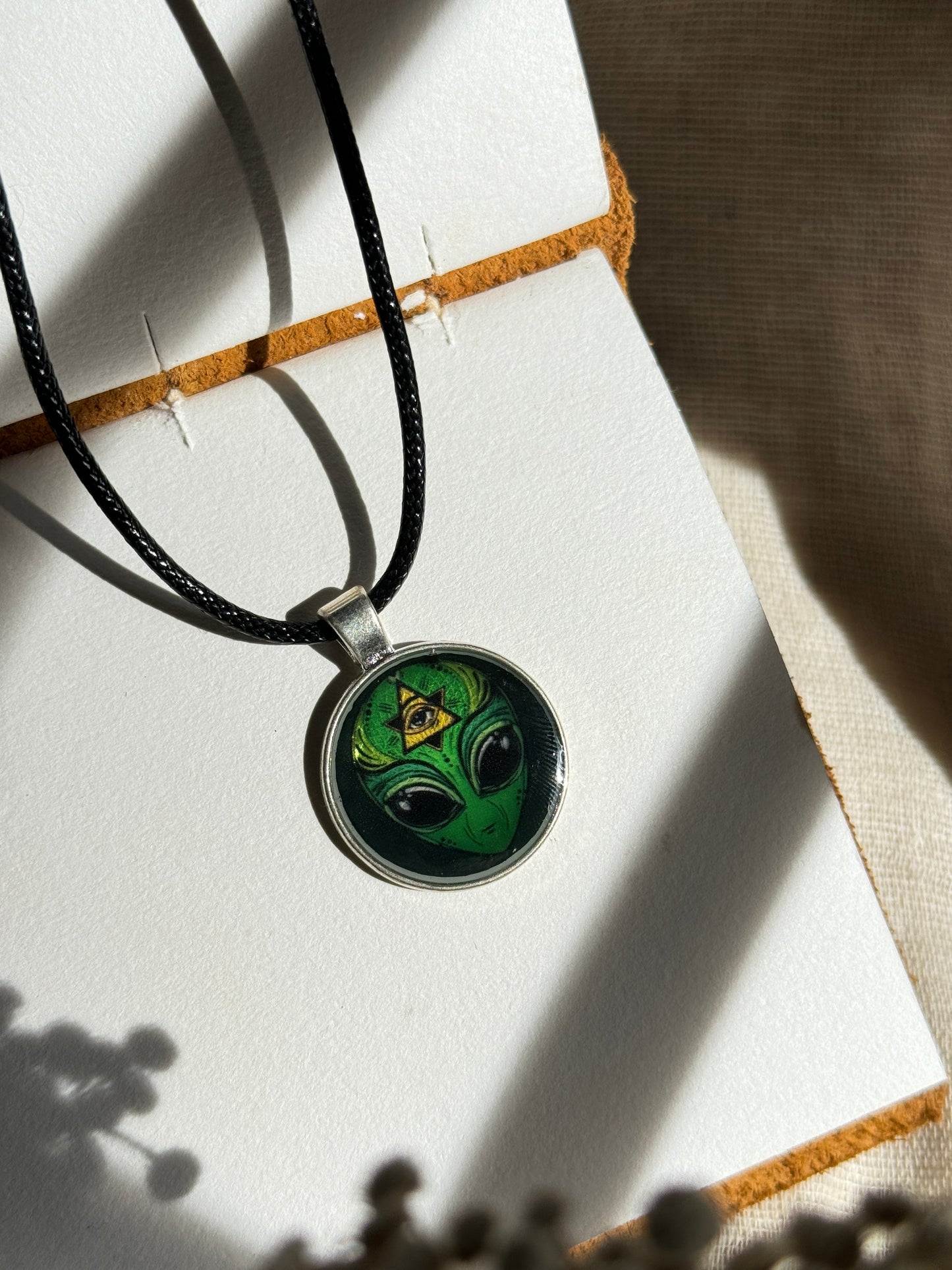 Glow in the dark green alien resin necklace