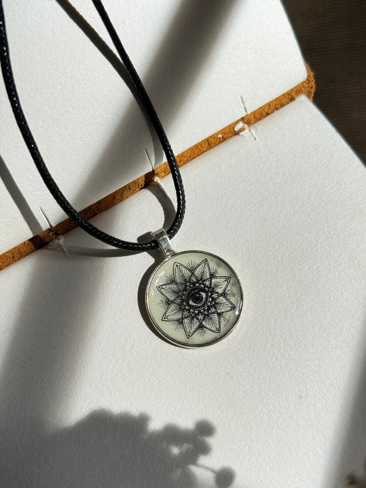 Glow in the dark eye mandala b/w resin necklace
